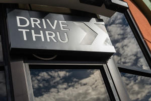 Coffee drive thru sign with reflect from glass window