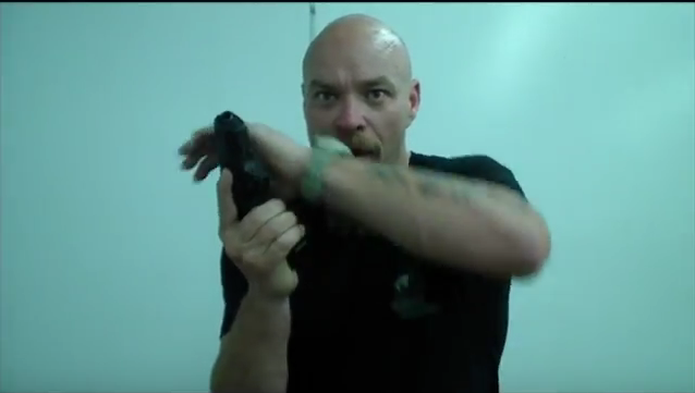 screenshot of James Yeager demonstrating how keeping the firing hand elbow in keeps the gun up in your workspace